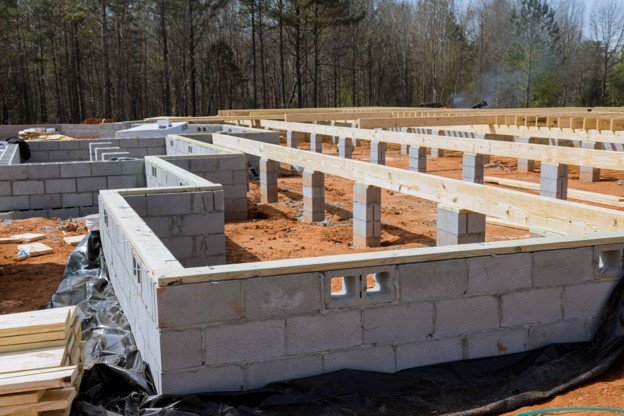 Concrete block foundation with floor framing system installed during new home construction in North Ridgeville, OH