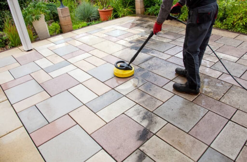 Cleaning and sealing decorative stamped concrete patio surface in residential backyard in North Ridgeville, OH