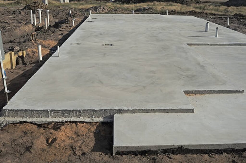 Newly poured concrete slab foundation with smooth finish and structural layout in North Ridgeville, OH